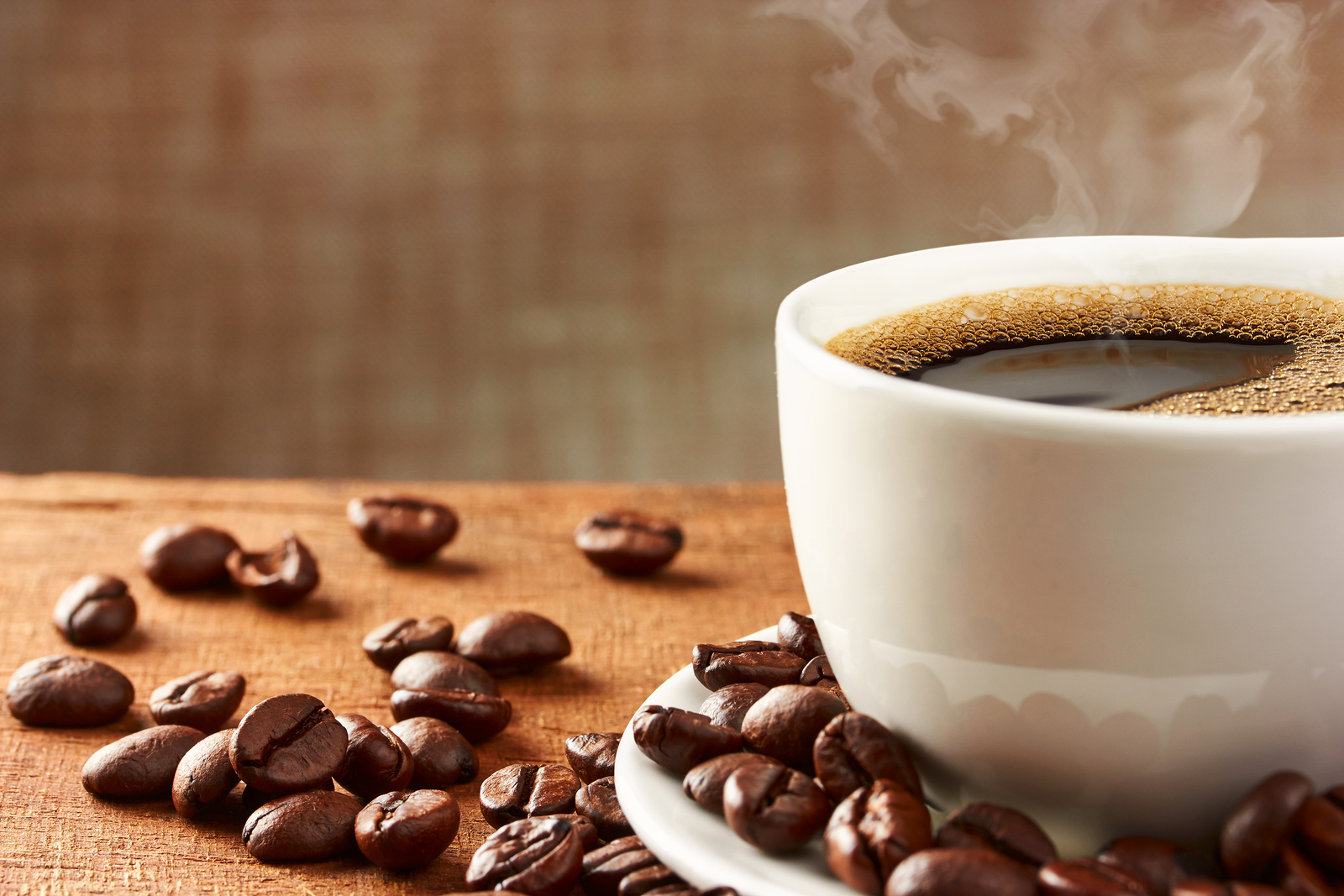 Coffee cup and coffee beans on table