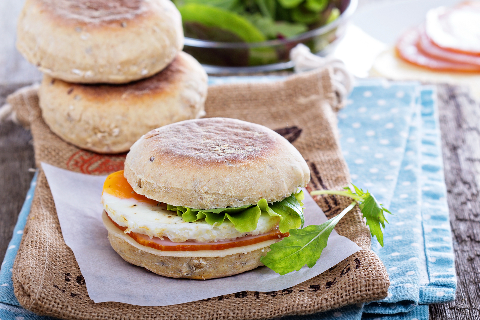 English muffin with egg, cheese and ham for breakfast